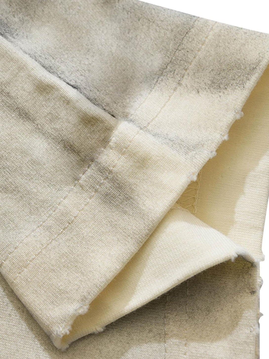 Detailed fabric and stitching on TALISHKO T-shirt, showcasing the unique dirty wash effect.