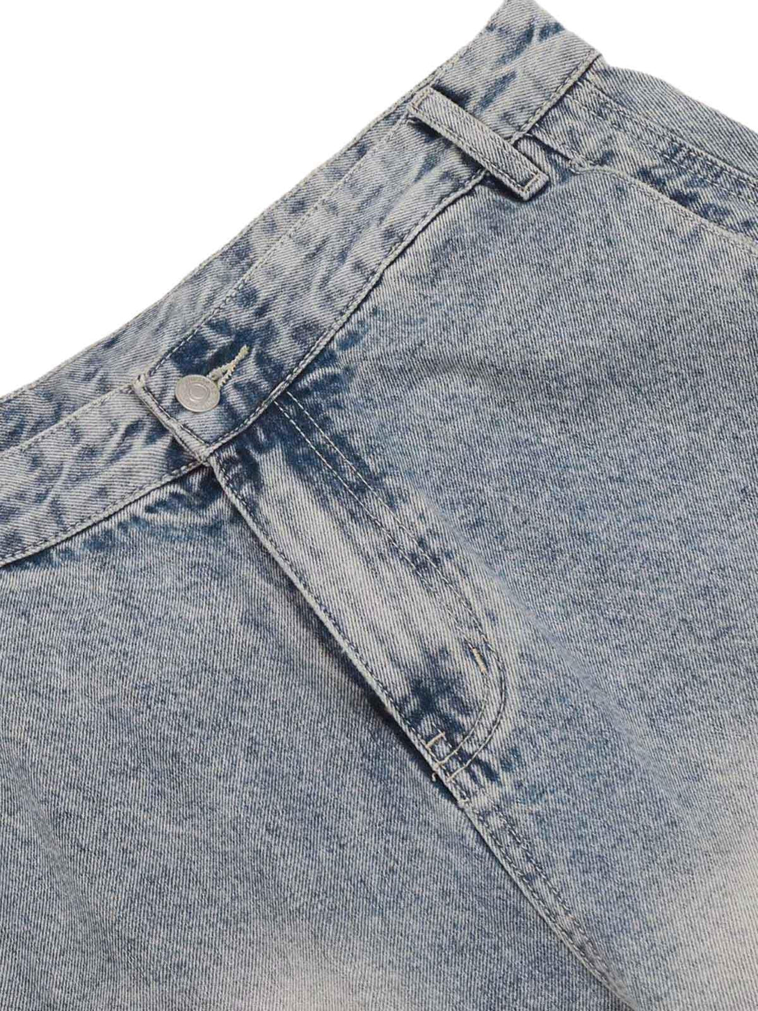 Detailed fabric and stitching of TALISHKO distressed baggy barrel jeans, highlighting denim texture.