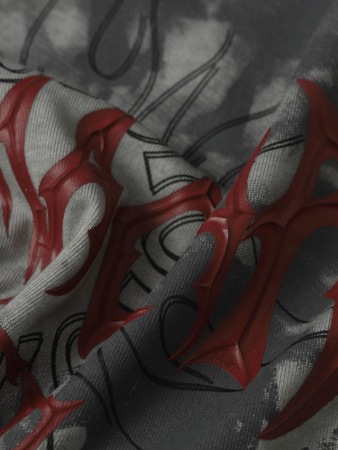 Texture and pattern showcased in a TALISHKO distressed batik graphic T-shirt with bold red accents.