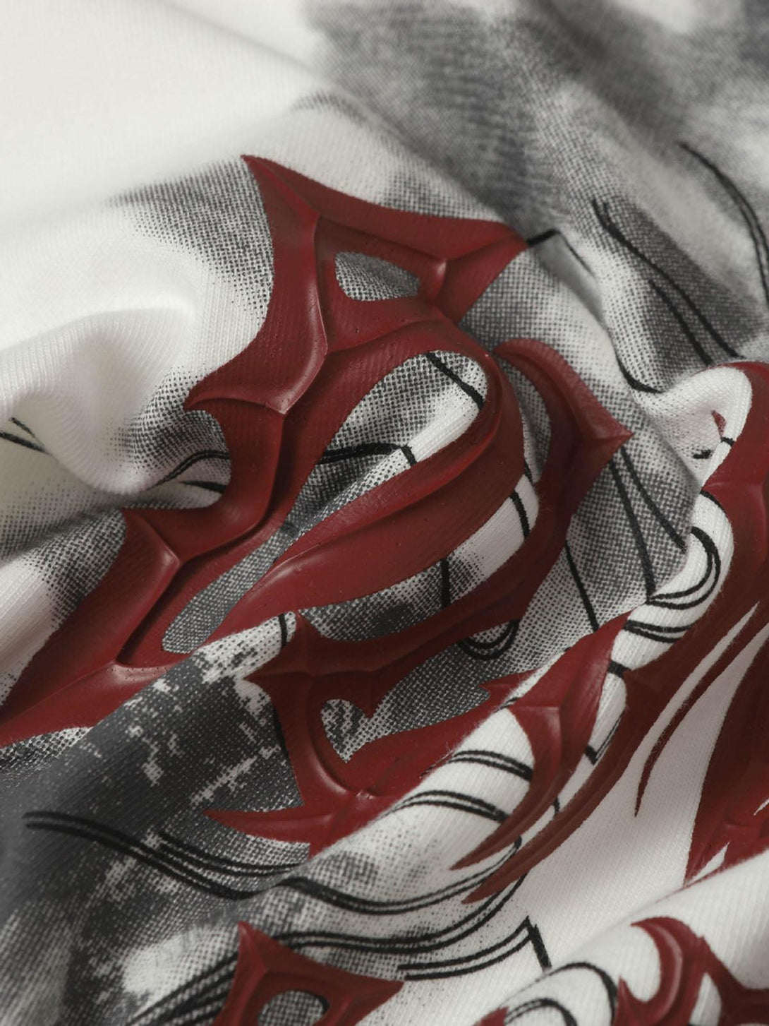 A tight crop highlighting the bold design on a TALISHKO distressed batik graphic T-shirt.