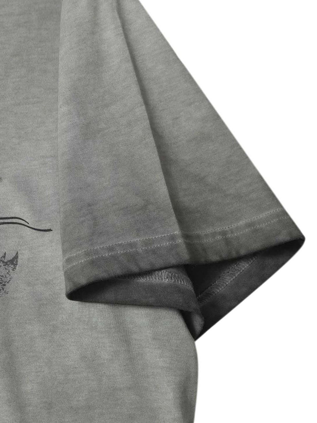 Close-up of the sleeve detailing on a TALISHKO distressed batik graphic T-shirt.