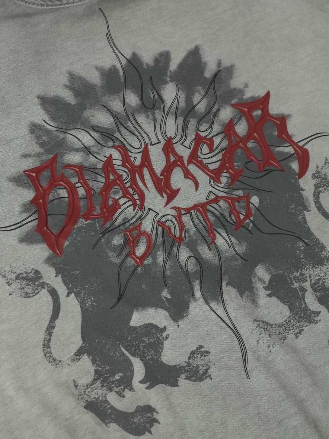 A close-up of the bold design on a TALISHKO distressed batik graphic T-shirt.