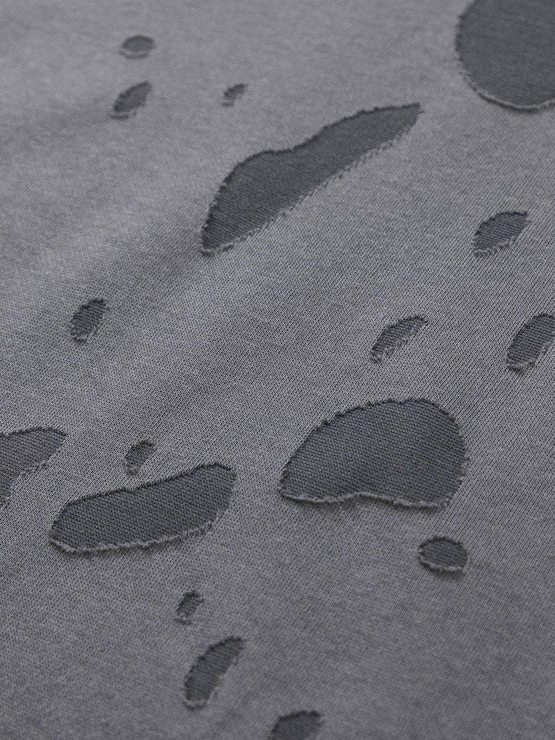 Texture and pattern showcased on a distressed tee by TALISHKO, highlighting unique details.