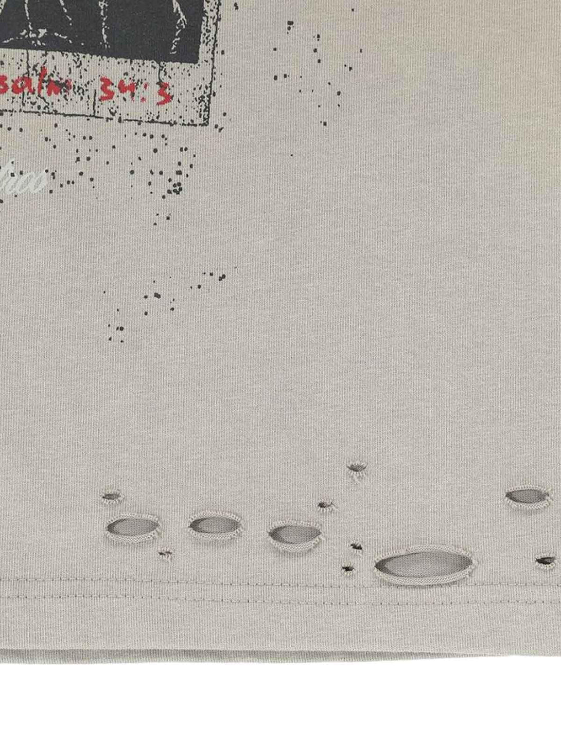 Distressed detail on TALISHKO graphic T-shirt fabric, showcasing unique texture and style.