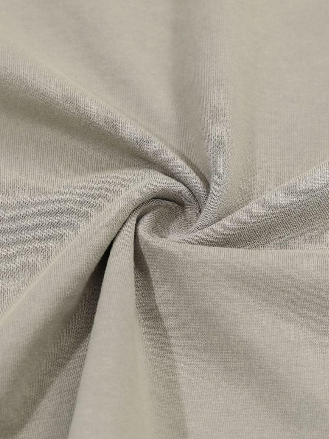 A tight crop highlighting the texture of TALISHKO's gray distressed faux two-piece T-shirt.