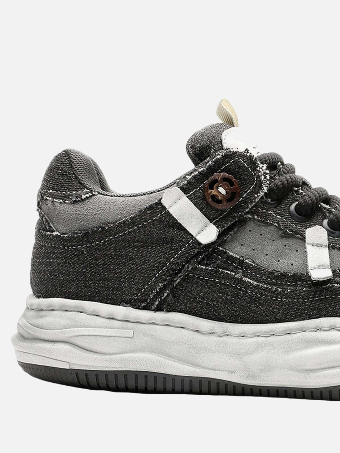 A detailed look at TALISHKO's distressed platform sneaker, highlighting its rugged texture.