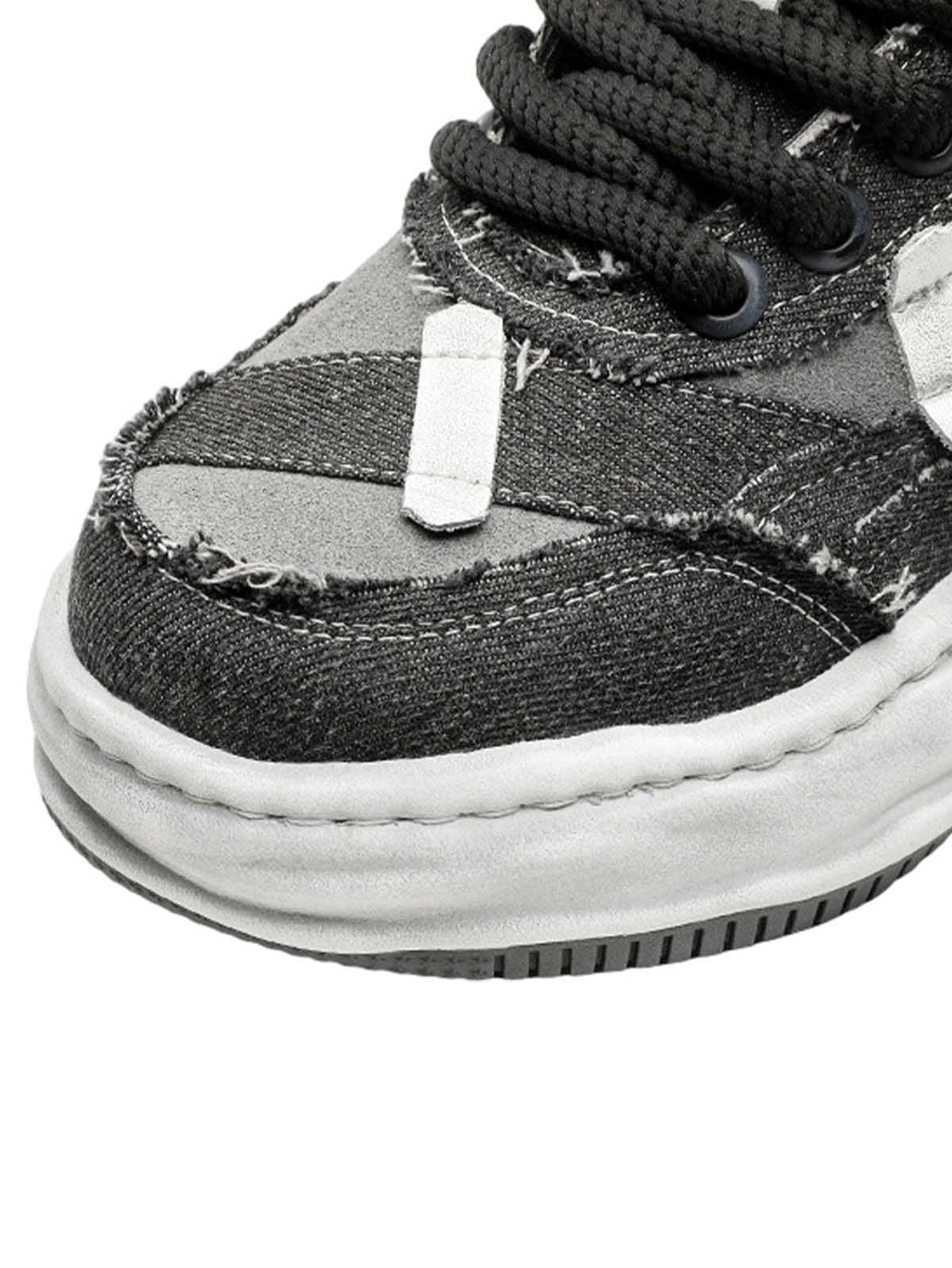Zoomed-in texture of TALISHKO's distressed platform sneaker, featuring unique stitching detail.