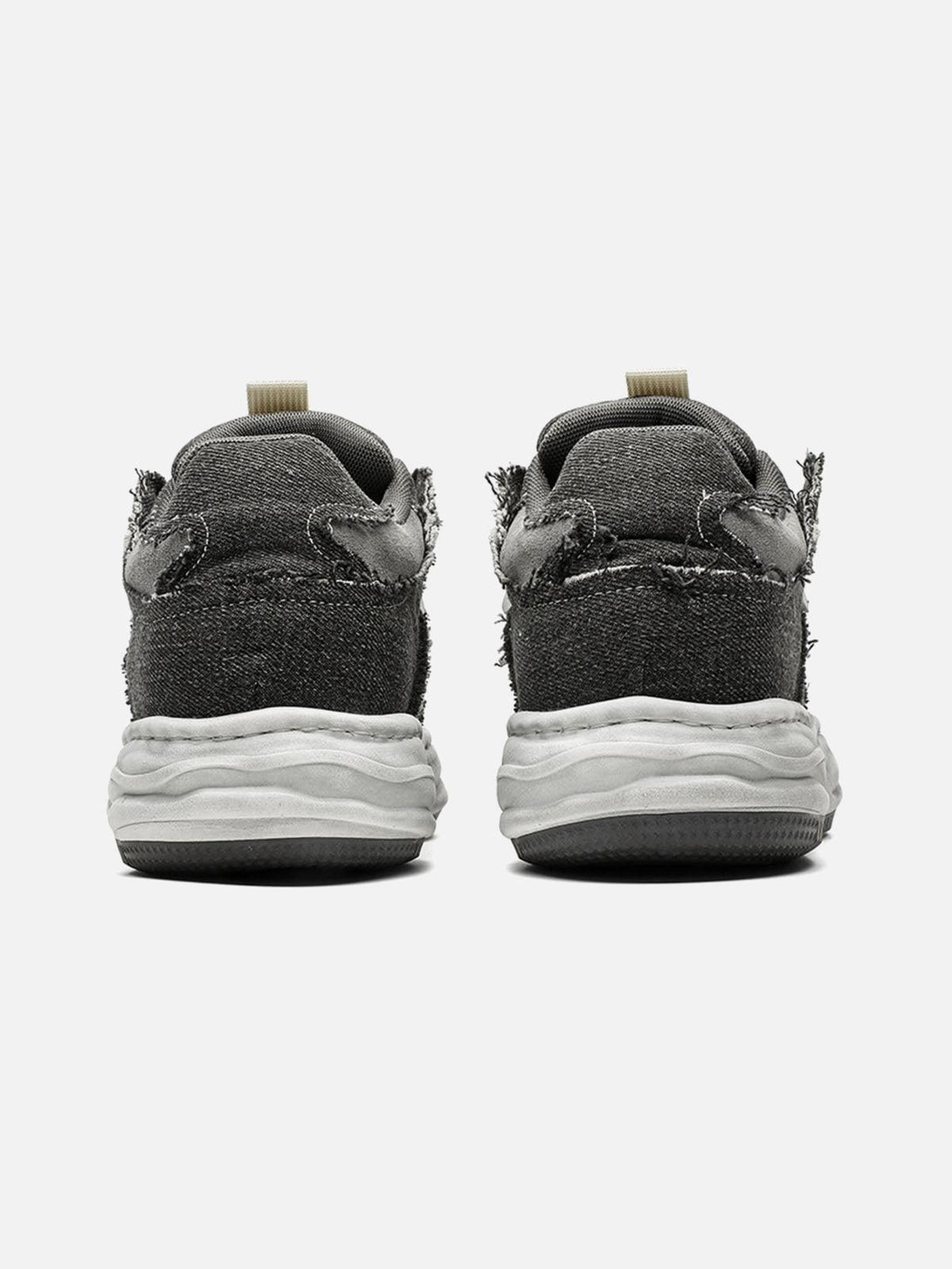 Back view of TALISHKO distressed platform sneakers, showcasing their rugged, deconstructed style.