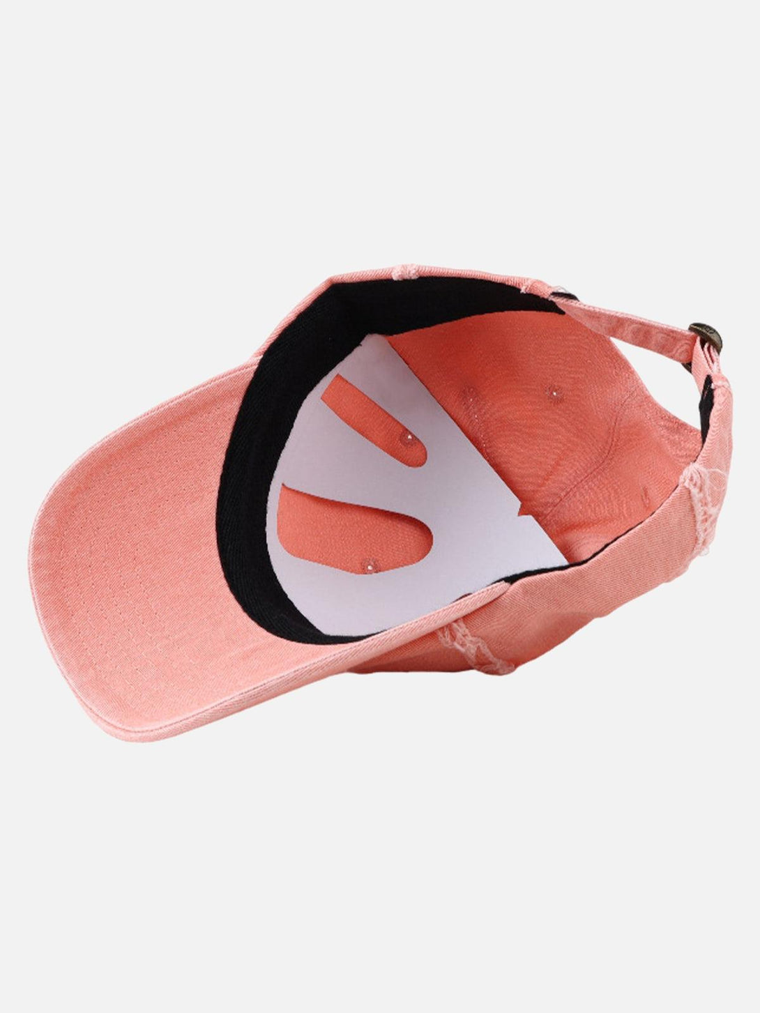 Inside view of a pink distressed denim baseball cap by TALISHKO, highlighting detailed stitching.