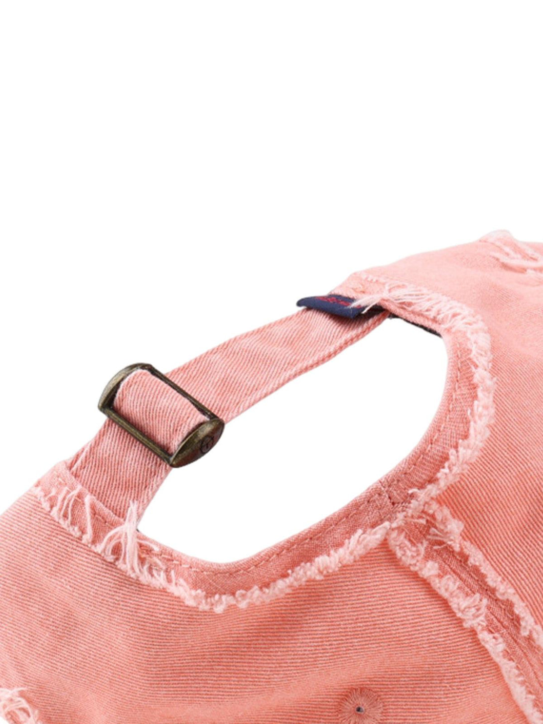 Detailed view of pink distressed denim cap by TALISHKO, showcasing frayed edges and buckle.