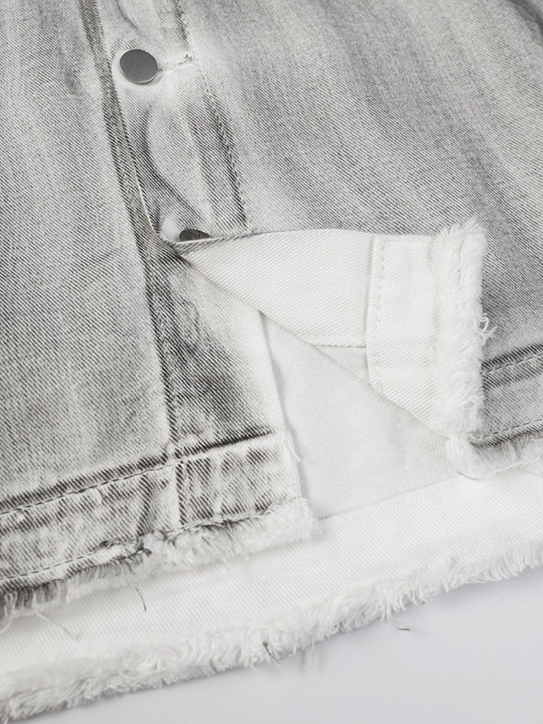 Detailed fabric and stitching on TALISHKO's distressed denim jacket, highlighting rugged texture.