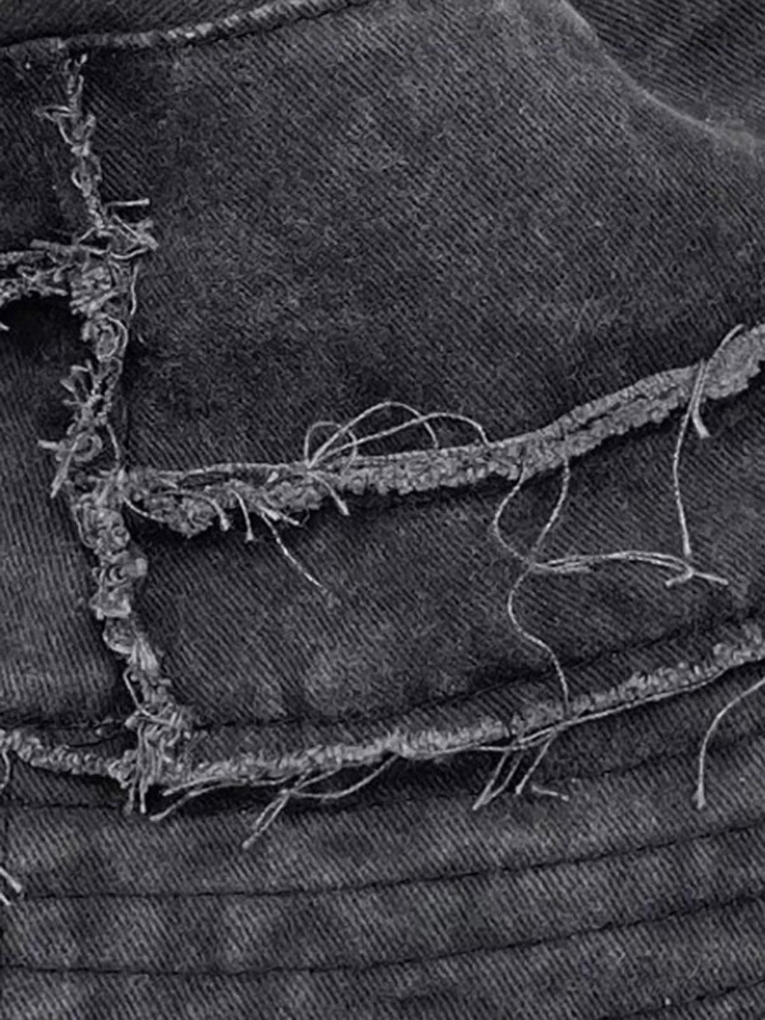 Intricate look at TALISHKO's distressed denim bucket hat, featuring raw edges and frayed details.