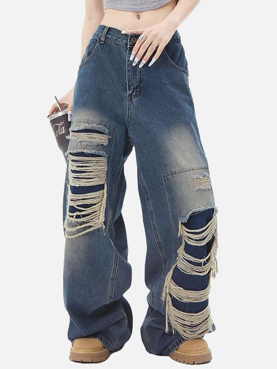 TALISHKO distressed loose jeans with bold ripped details, showcasing a trendy streetwear style.