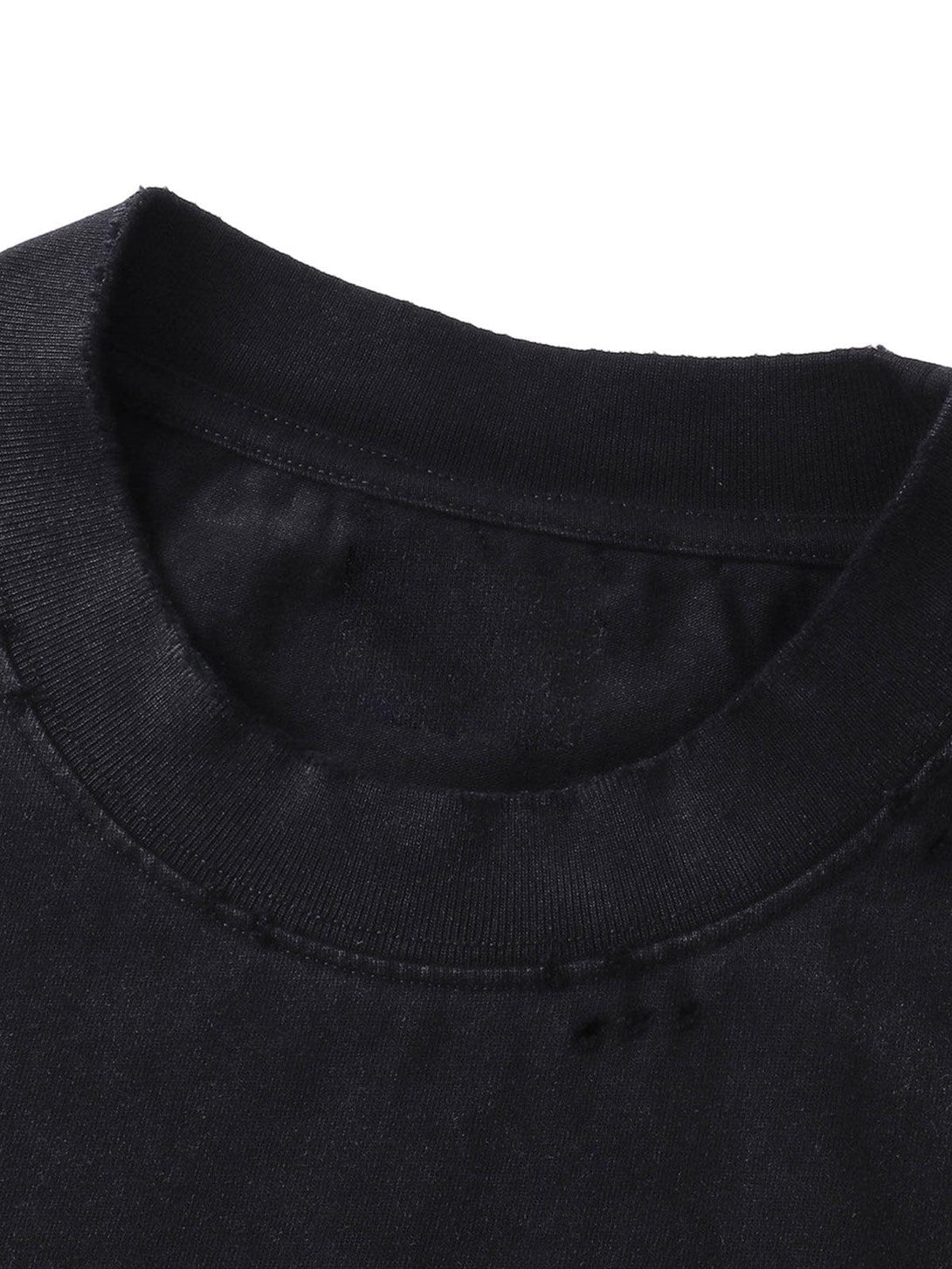 A close-up of the collar on the black distressed T-shirt by TALISHKO, showcasing intricate stitching.