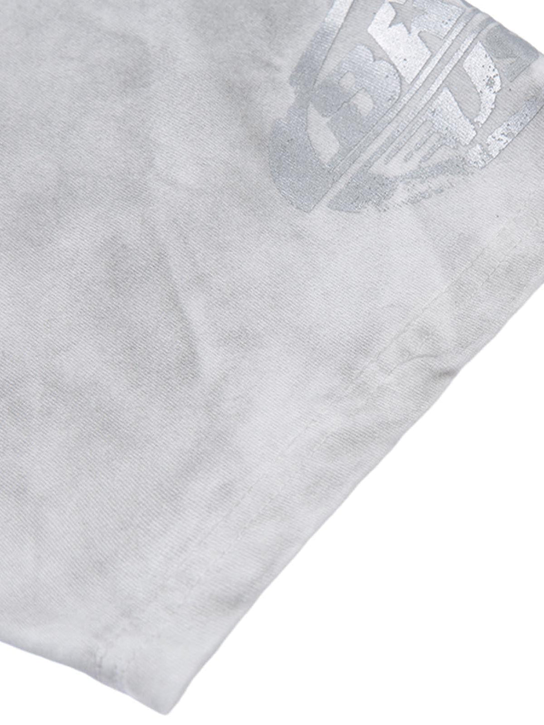 Detailed fabric and stitching of a TALISHKO T-shirt, showcasing unique distressed texture.