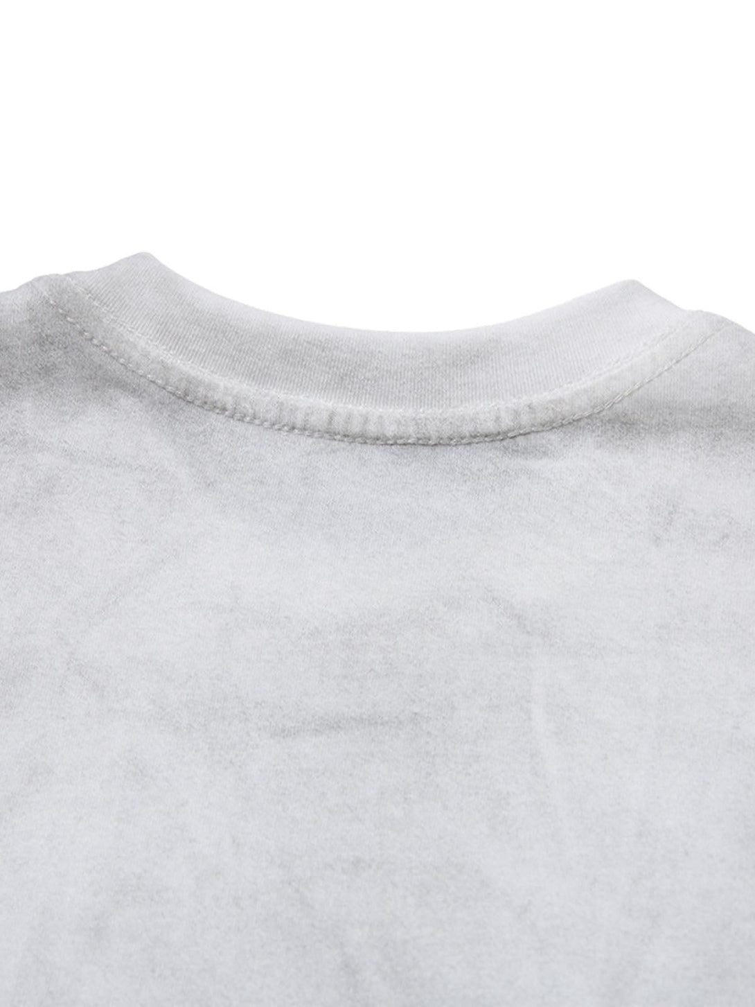 Zoomed-in view of the distressed fabric on a T-shirt by TALISHKO, showcasing unique texture.