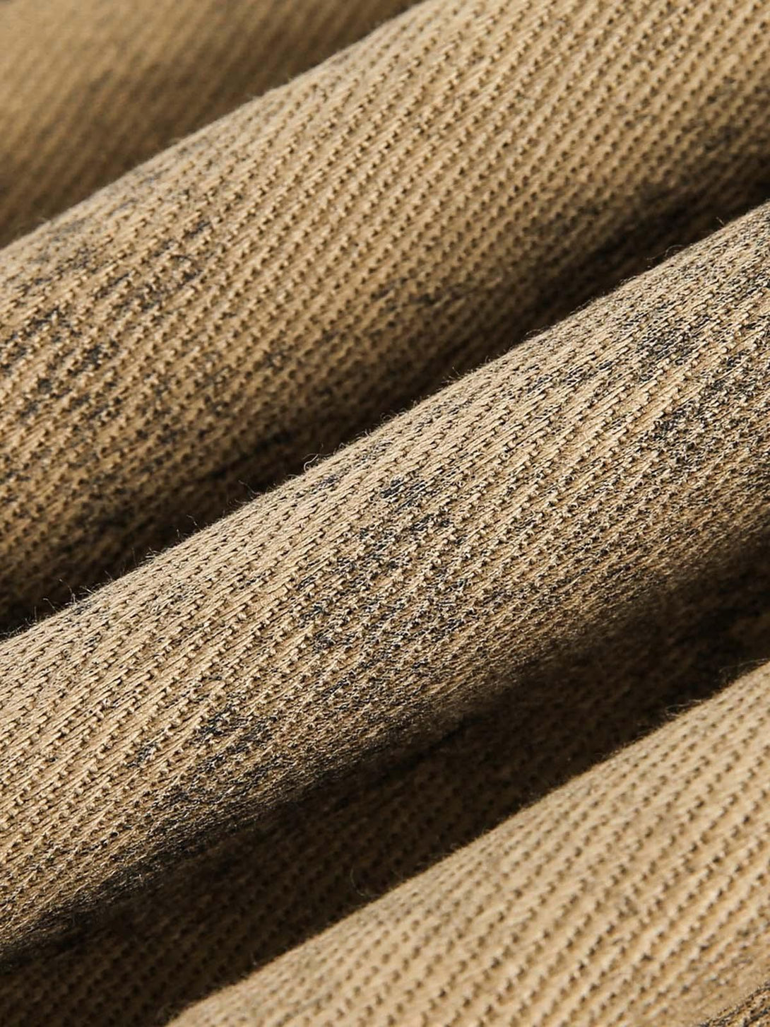 Texture and pattern showcased on TALISHKO jacket's distressed fabric in a close-up view.