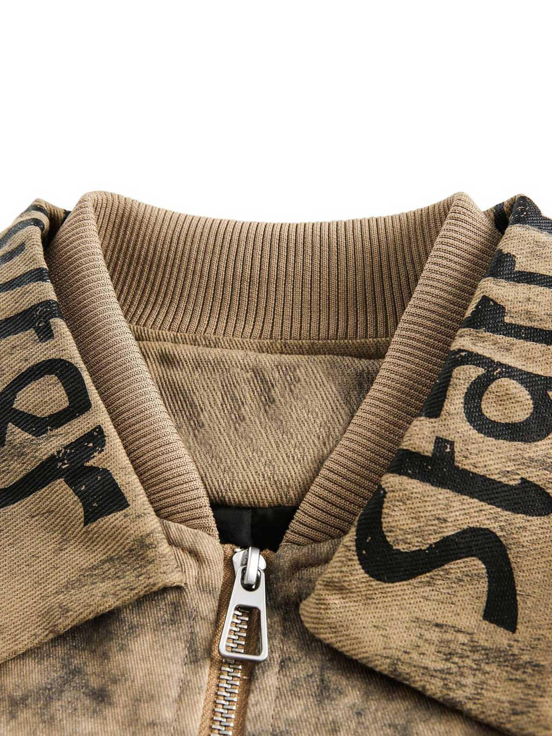 Intricate look at TALISHKO jacket's double-layer collar with distressed fabric and text details.