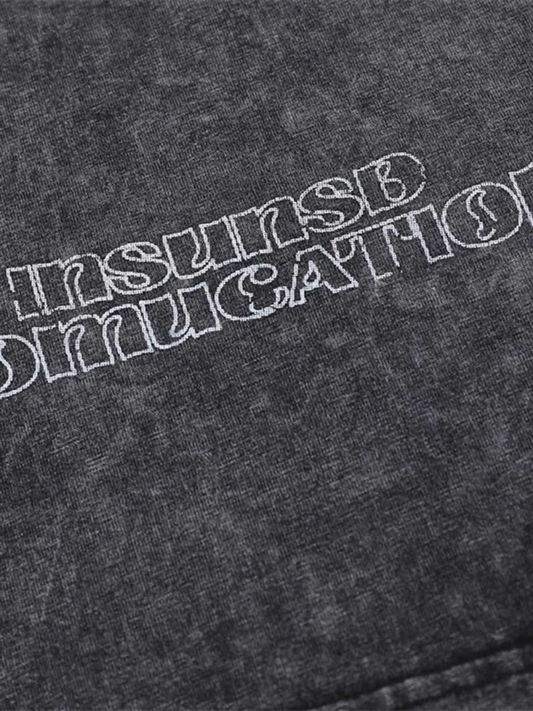 Intricate embroidery detail on TALISHKO's distressed polo shirt, highlighting unique texture.