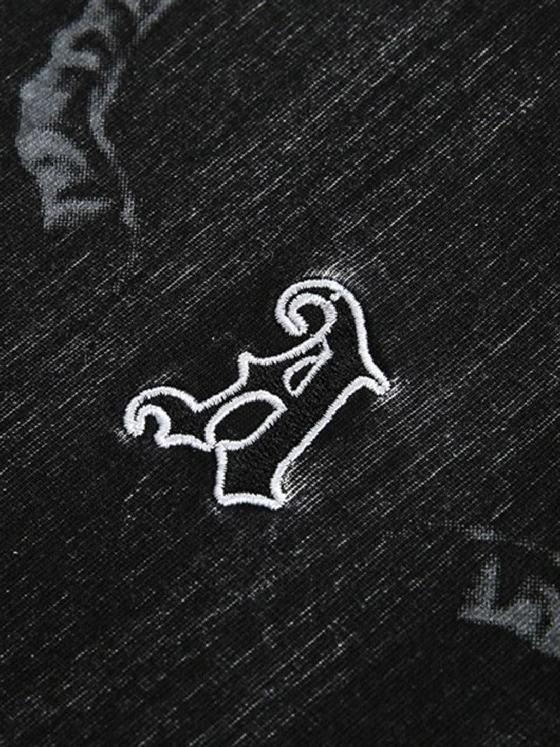 Intricate look at the embroidered detail on a black TALISHKO T-shirt, highlighting texture.