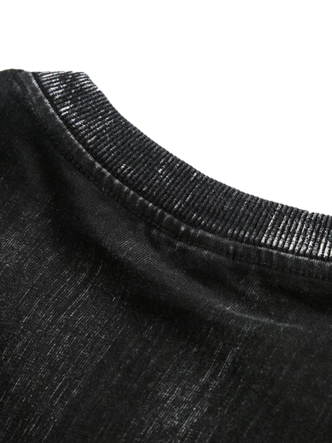 Detailed fabric and stitching on a black distressed T-shirt by TALISHKO, showcasing texture.