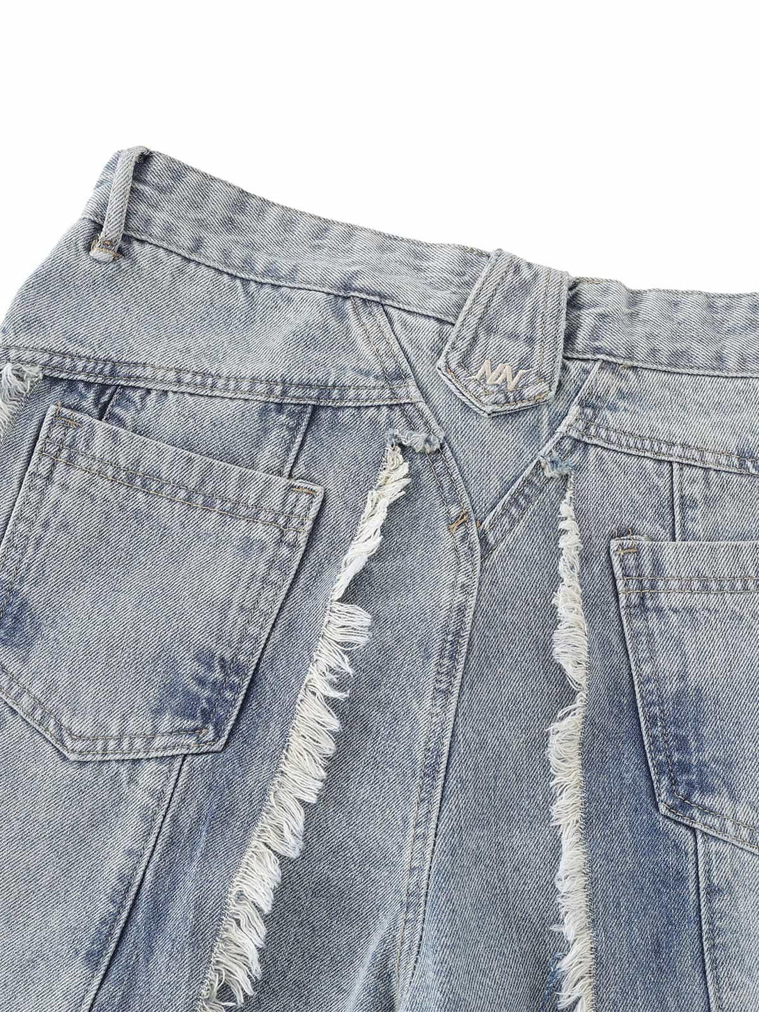 A detailed look at the frayed edges on TALISHKO's distressed baggy jeans, emphasizing unique style.