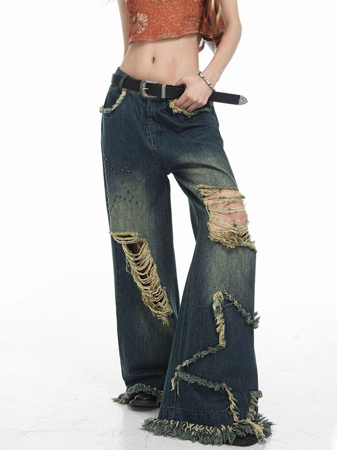 TALISHKO distressed fringe star jeans worn by model, showcasing edgy denim style and texture.