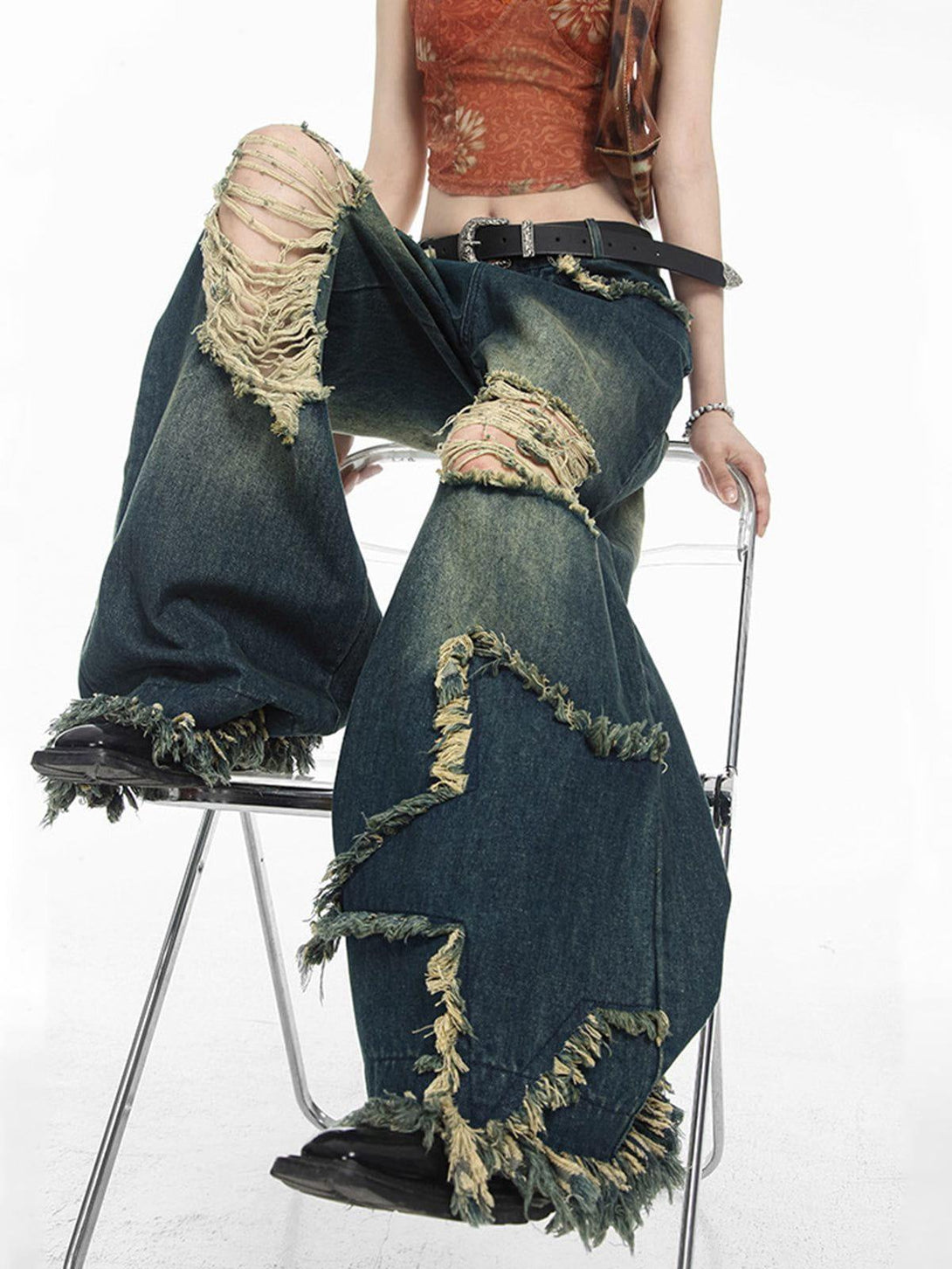 Model wearing TALISHKO distressed fringe star jeans with a vintage-inspired look.