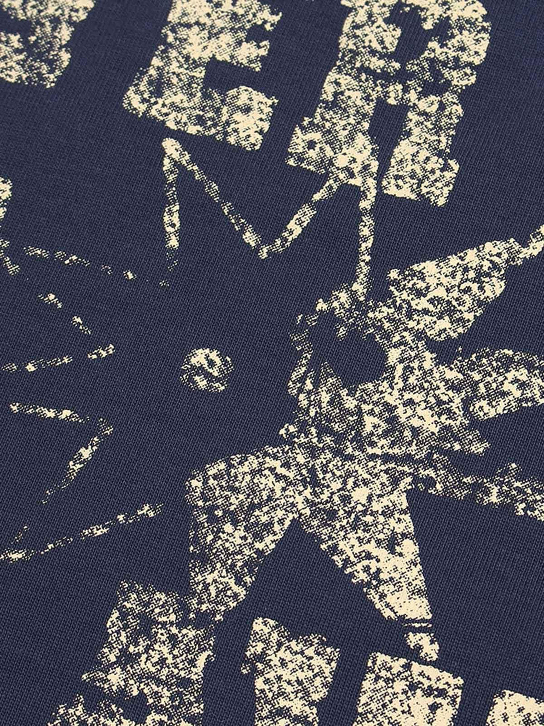 Intricate look at distressed print on a navy TALISHKO crew neck T-shirt, highlighting texture.
