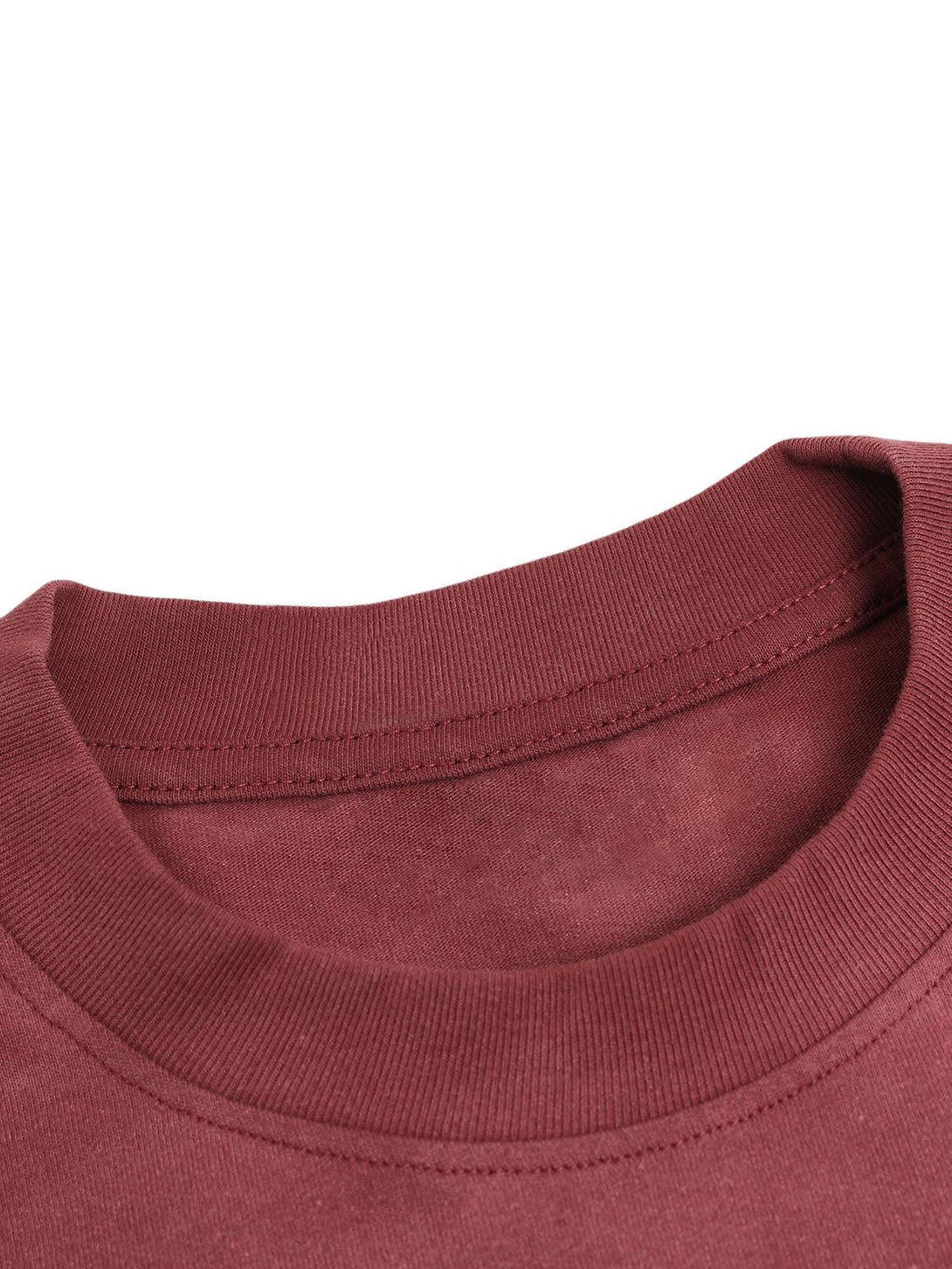 Intricate look at the neckline of a red TALISHKO T-shirt, highlighting its fine stitching.