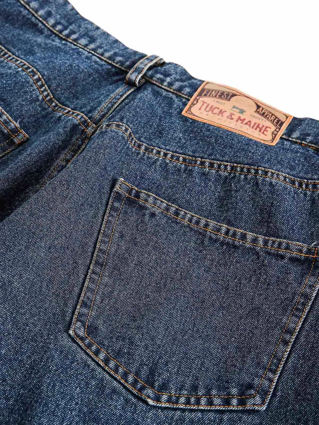 Focusing on the TALISHKO jeans' back pocket, highlighting the sturdy denim and label detail.