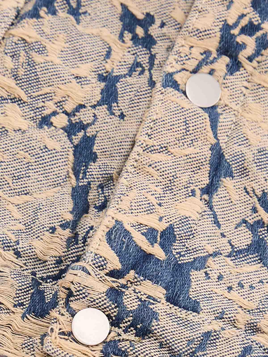 Intricate look at TALISHKO's distressed jacquard denim jacket, highlighting texture and detail.