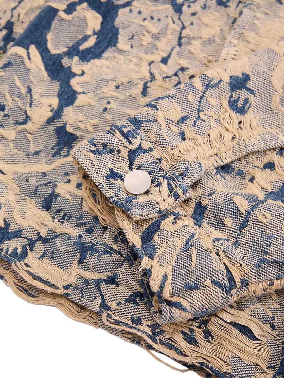 Zoomed-in texture of TALISHKO's distressed jacquard denim jacket, highlighting intricate details.
