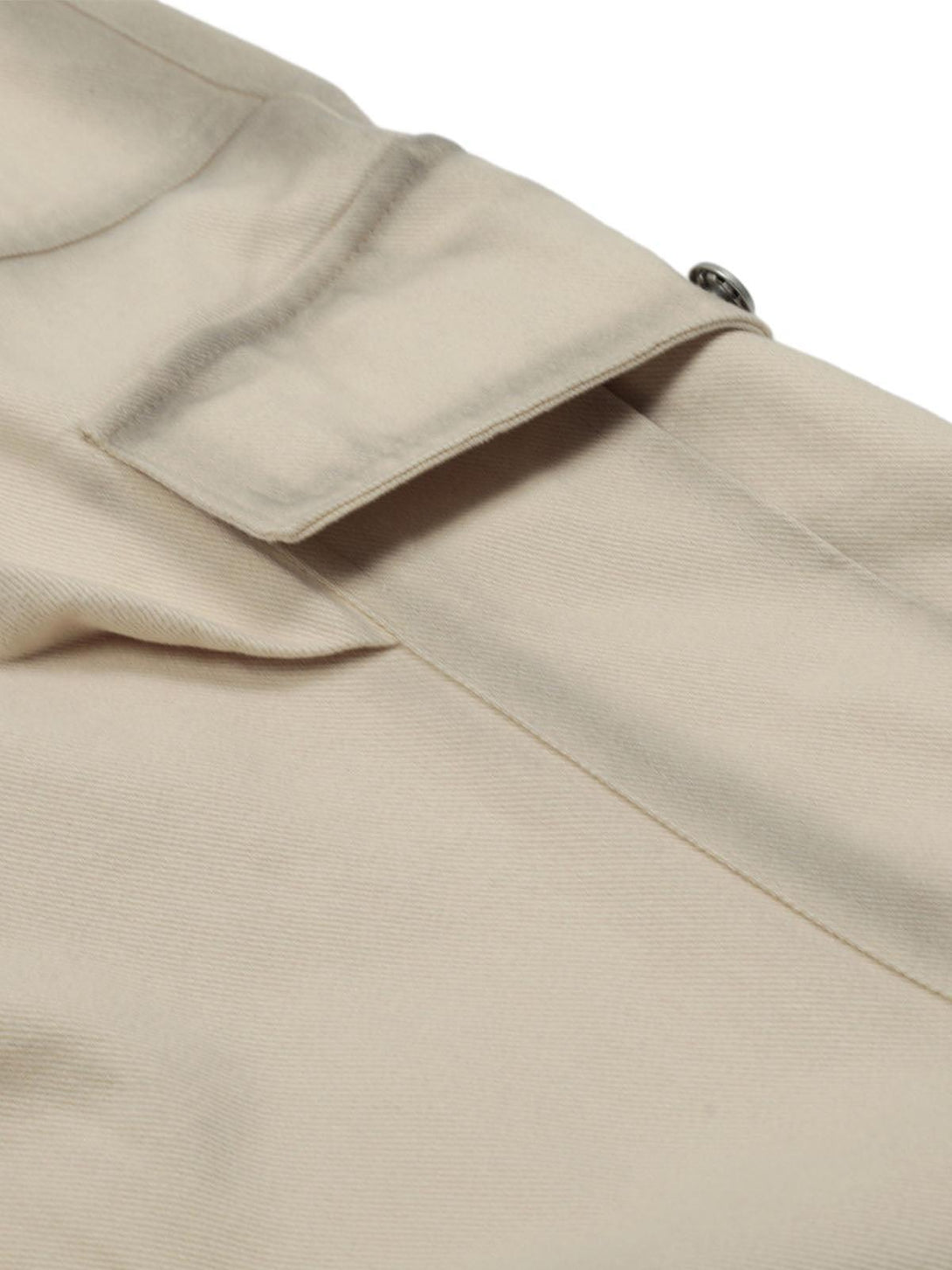Focusing on the beige cargo jorts by TALISHKO, highlighting their detailed pocket design.