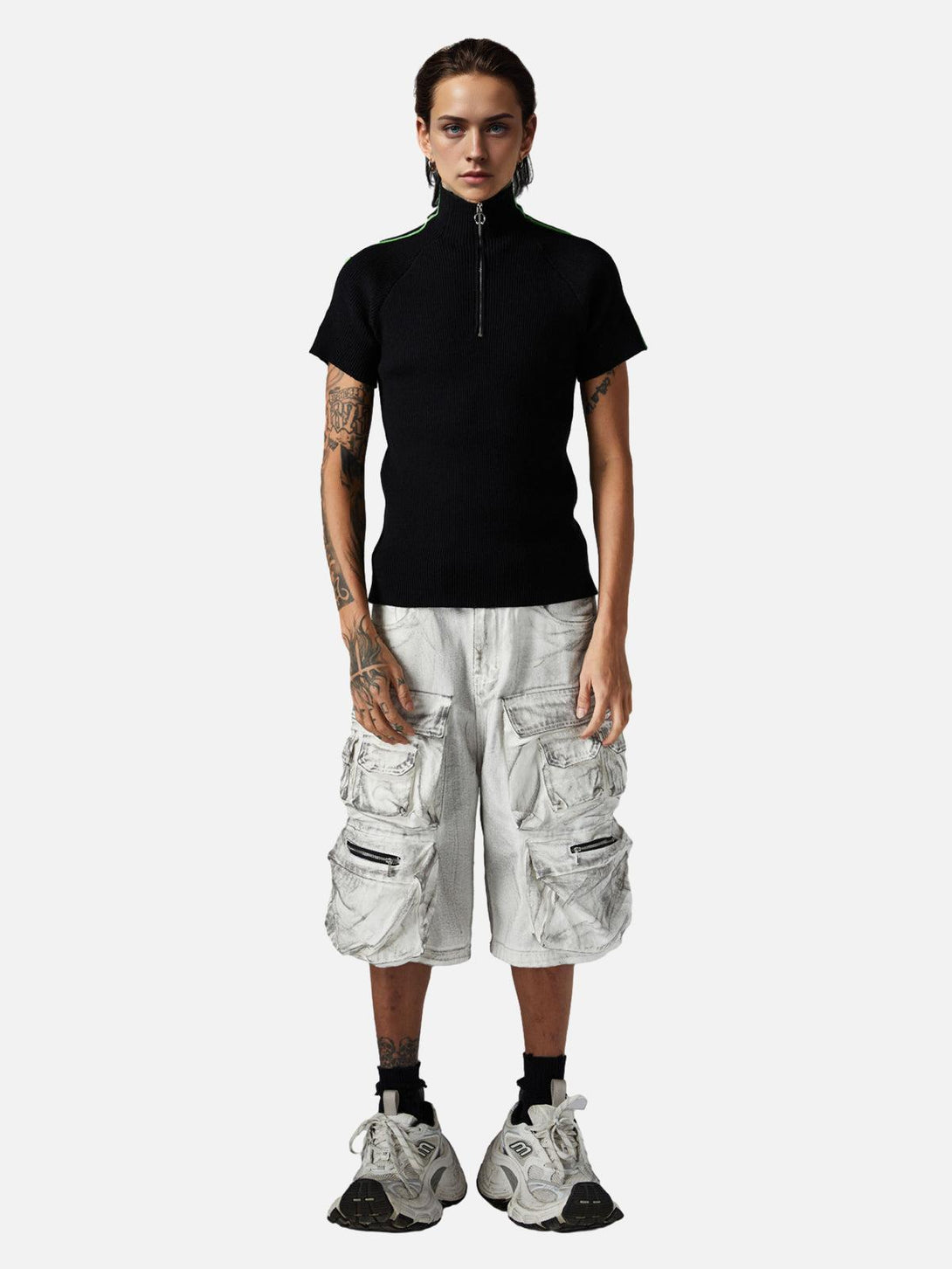 Model in TALISHKO black top and distressed cargo shorts, showcasing casual, edgy style.