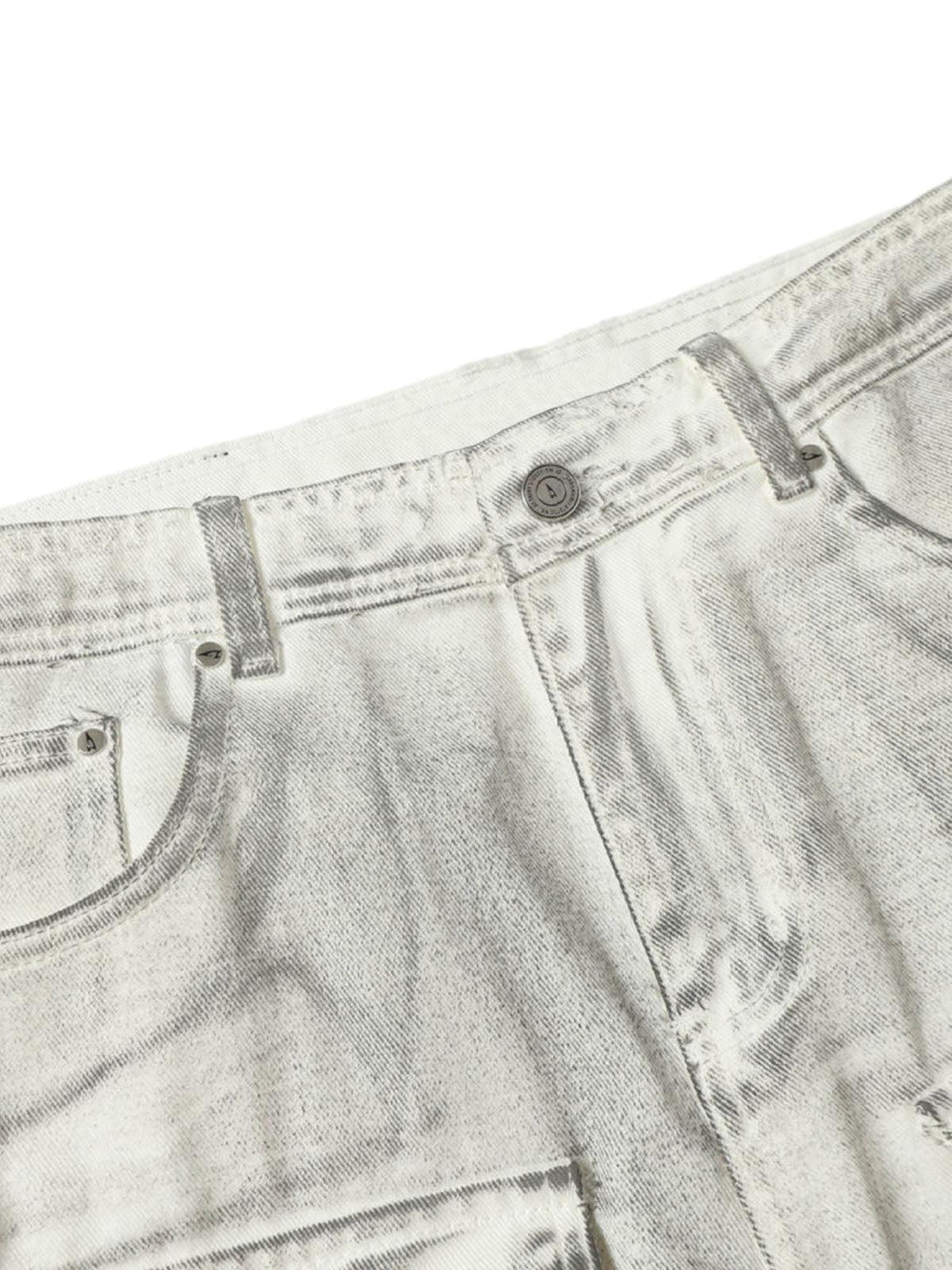 A tight crop highlighting the rugged texture and button detail of TALISHKO distressed shorts.