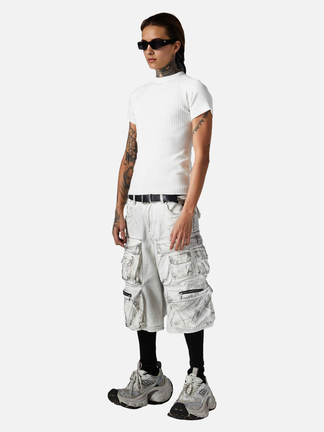 Model in TALISHKO distressed cargo shorts and white top, exuding a bold, streetwear vibe.