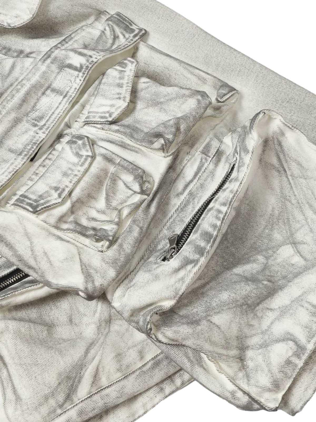 Intricate look at TALISHKO distressed cargo shorts, highlighting rugged pockets and texture.