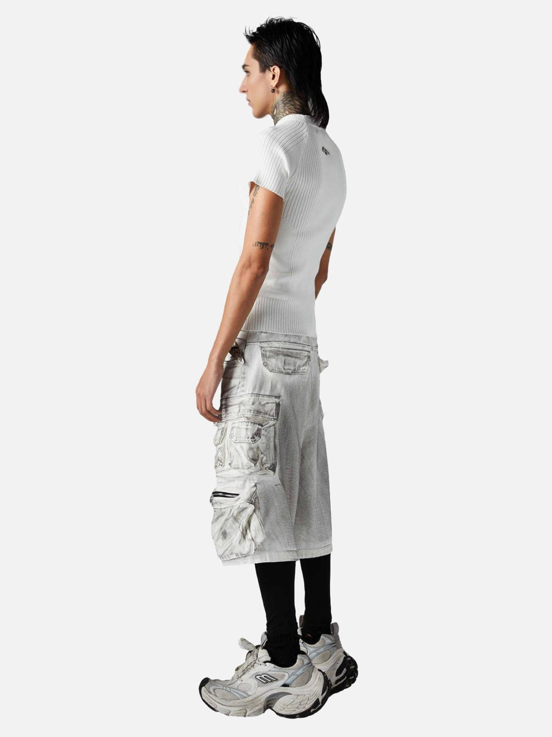 Model in TALISHKO distressed cargo shorts, highlighting side view and edgy street style.
