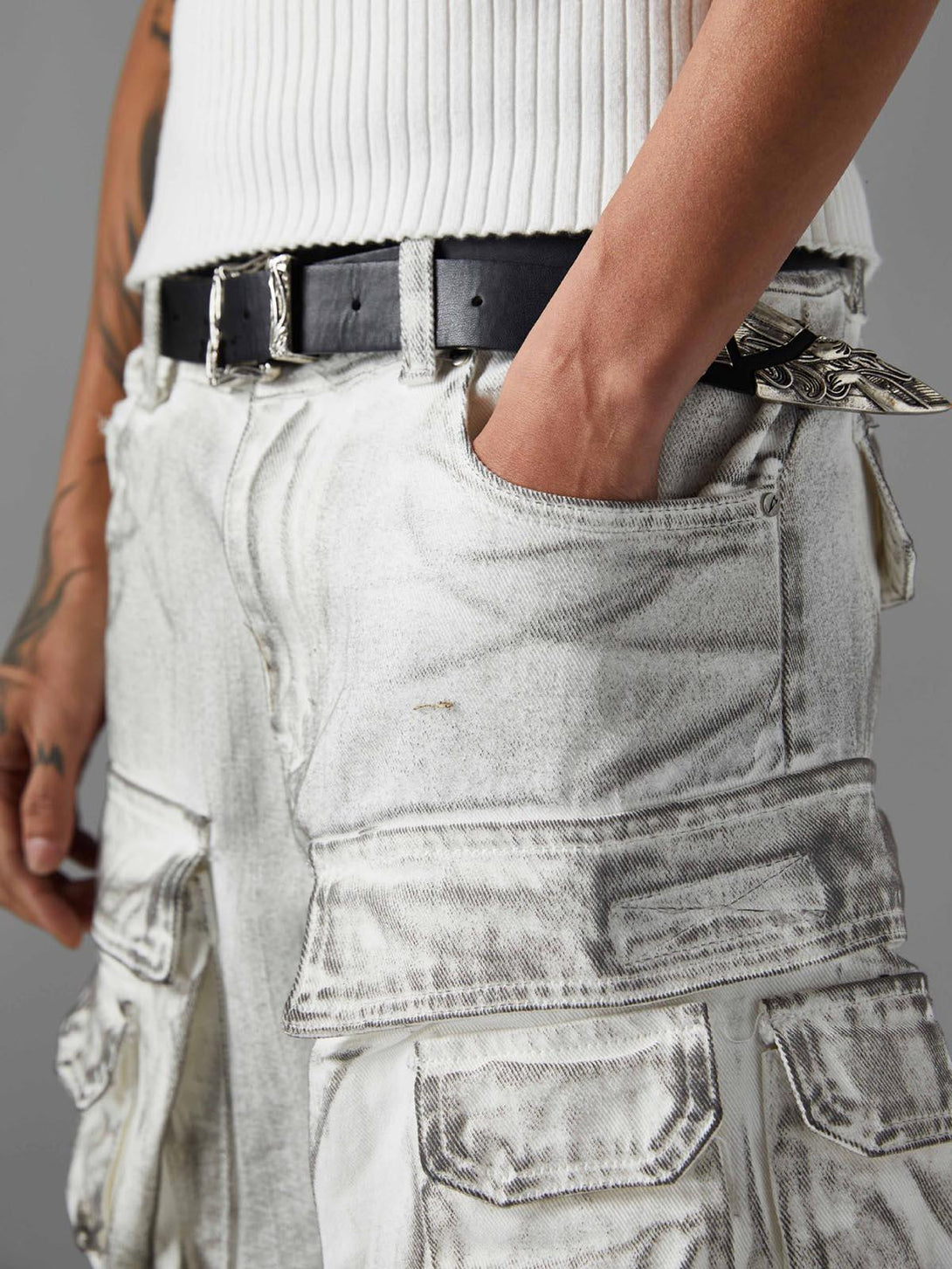 Model wearing TALISHKO distressed cargo shorts, highlighting rugged pockets and casual style.