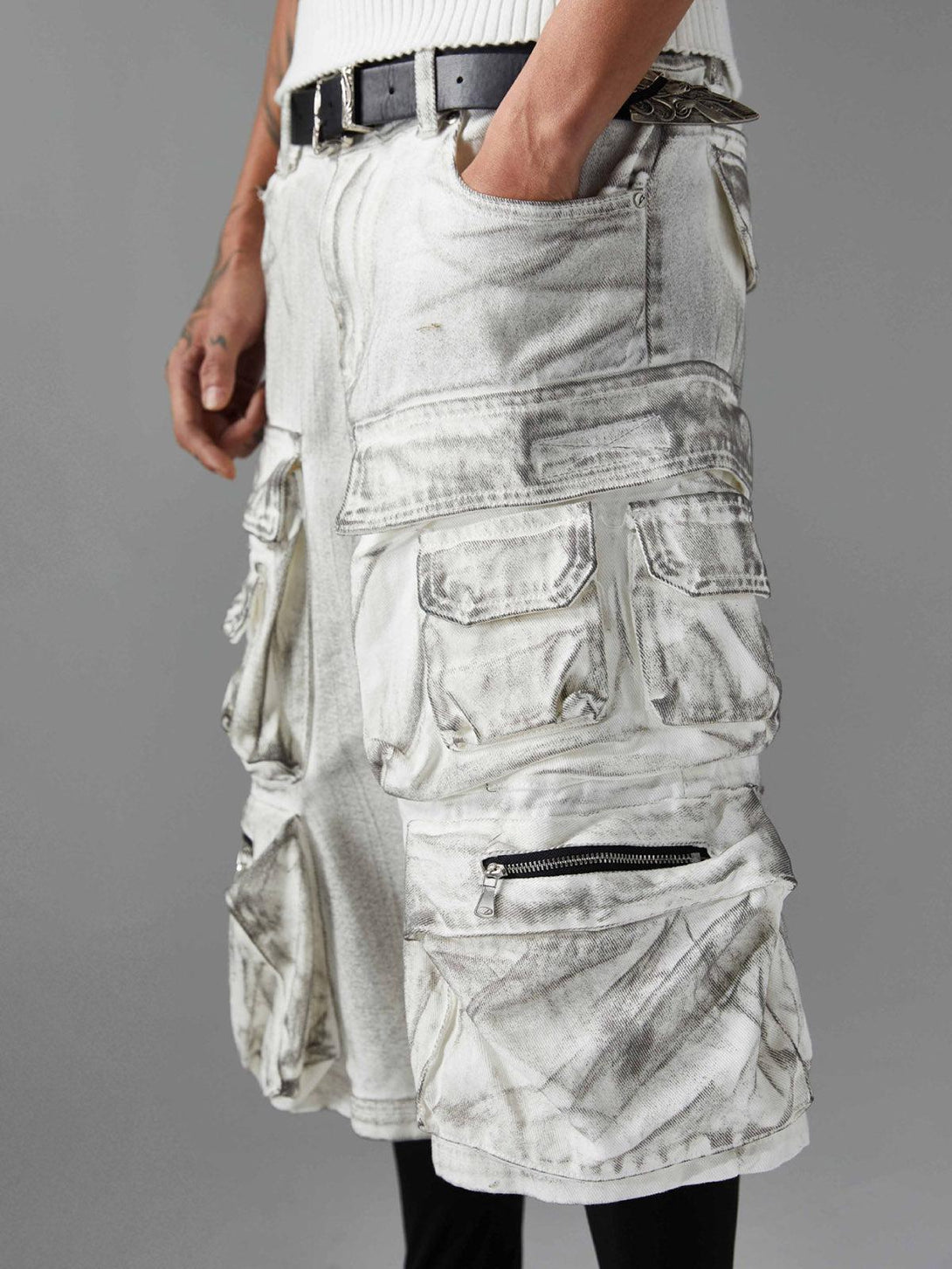 TALISHKO distressed cargo shorts with multiple pockets, highlighting rugged texture and style.