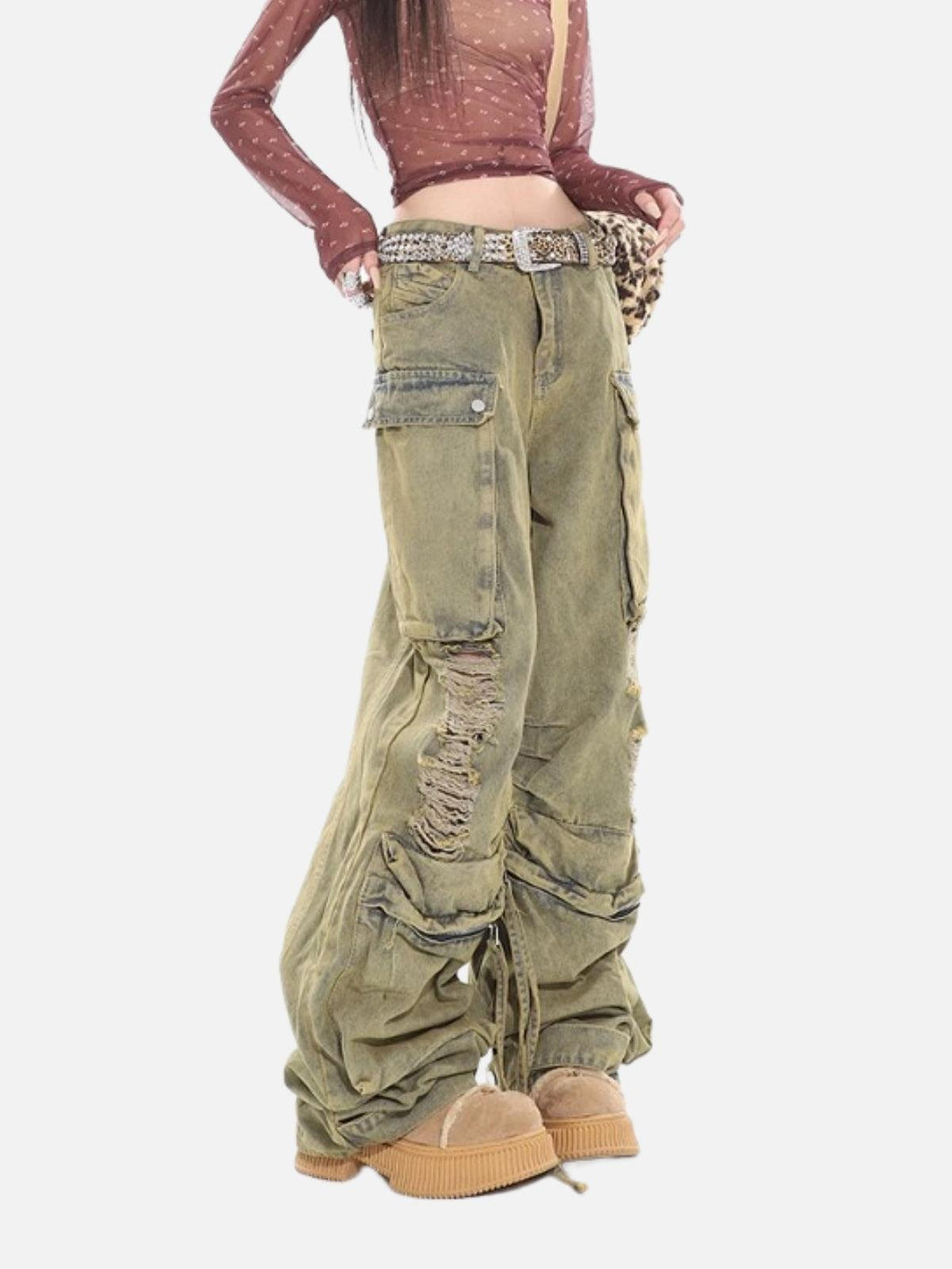 Model wearing distressed multi-pocket loose jeans by TALISHKO, highlighting a relaxed fit.
