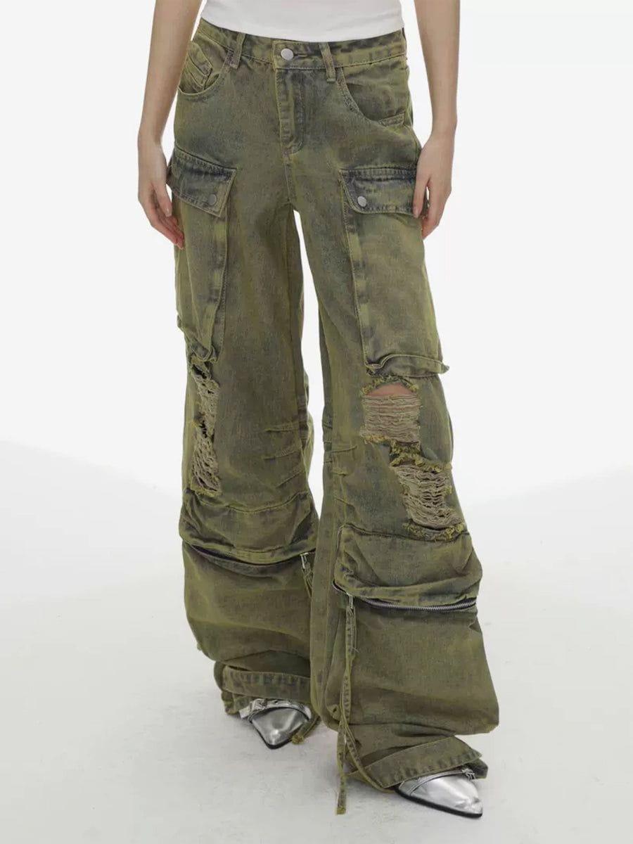 Model in green distressed loose jeans with multi pockets by TALISHKO, highlighting edgy fashion.