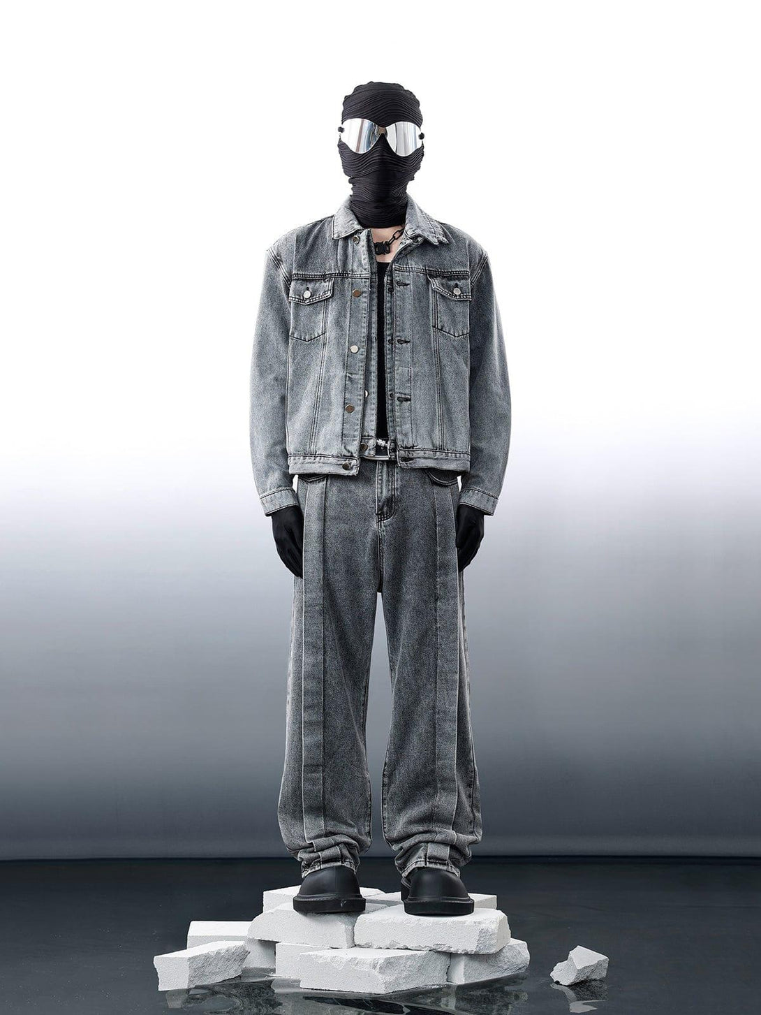 Model in TALISHKO distressed denim jacket and jeans, featuring a futuristic, edgy look.