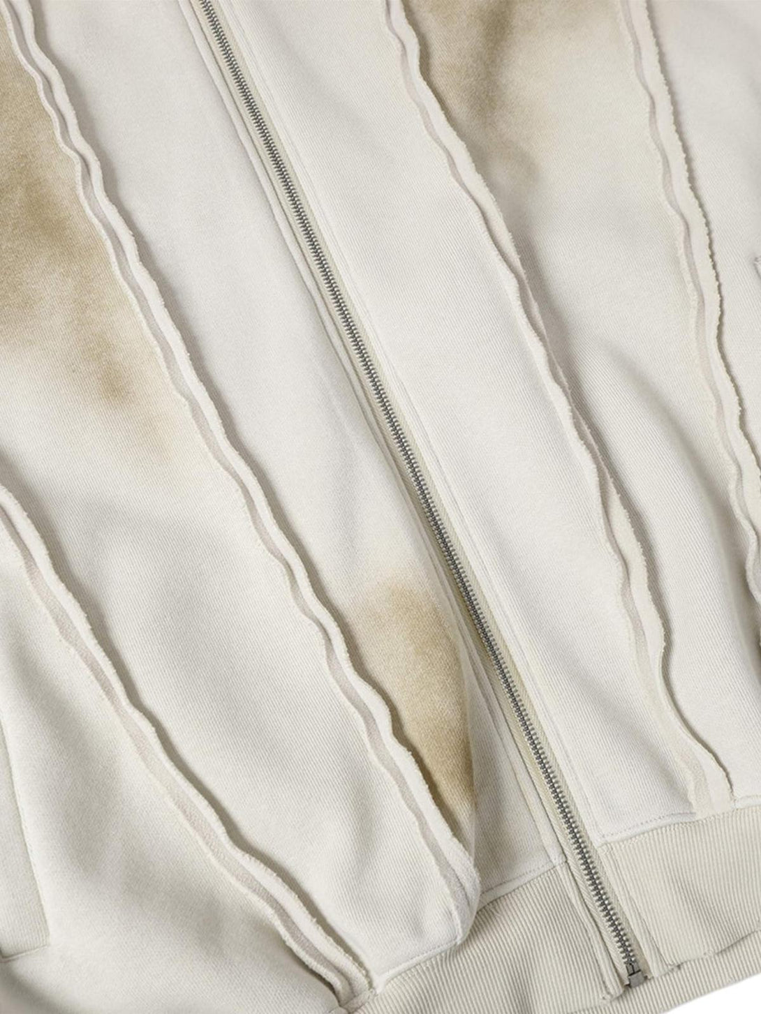 Detailed fabric and stitching on TALISHKO distressed patchwork velvet jacket, highlighting texture.