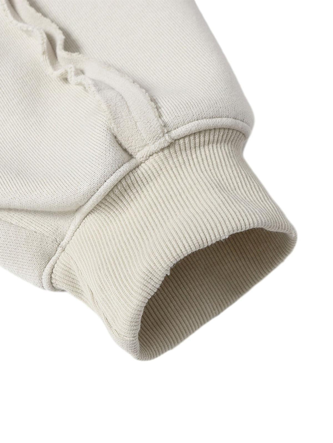 Detailed view of TALISHKO jacket sleeve, highlighting ribbed cuff and distressed texture.