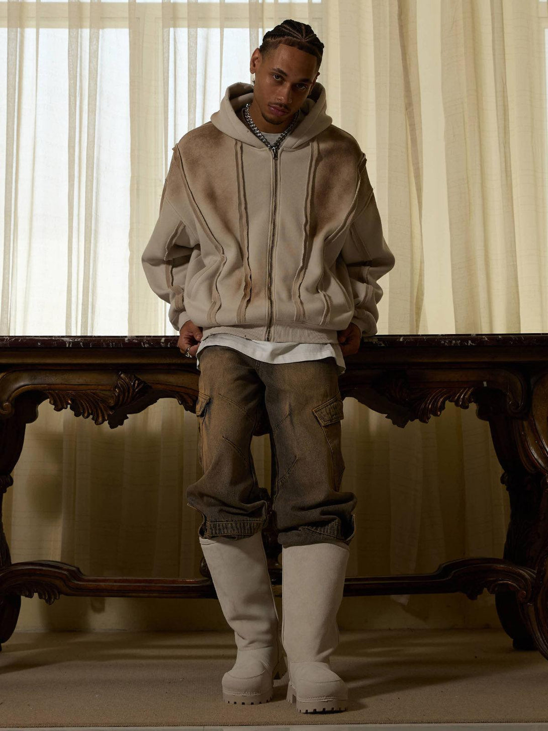 Model in TALISHKO distressed patchwork velvet jacket, styled with cargo pants and light boots.