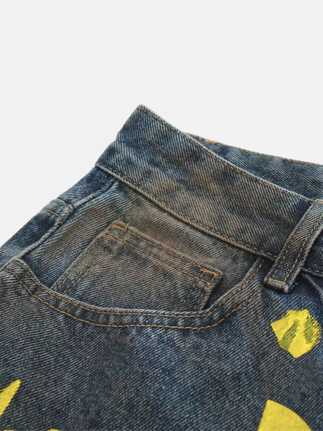 Focusing on the front pocket, TALISHKO bootcut jeans feature a bold yellow pigment print.