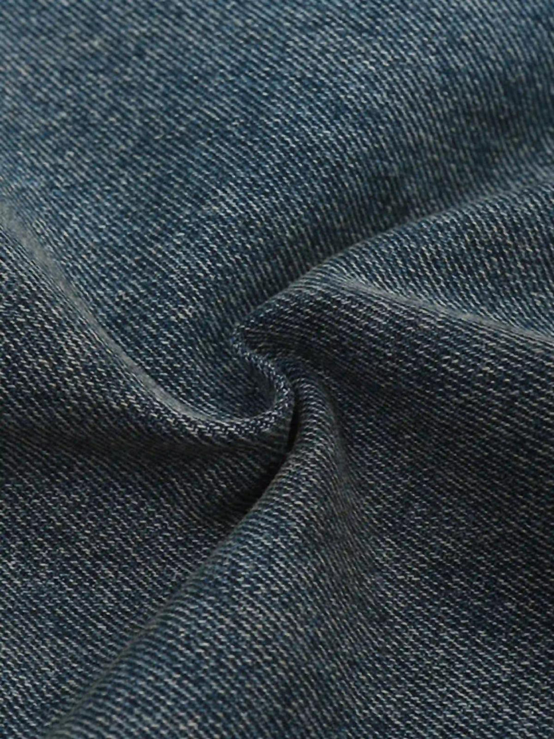 Zoomed-in texture of TALISHKO bootcut jeans, featuring the detailed pigment print and distressed fabric.
