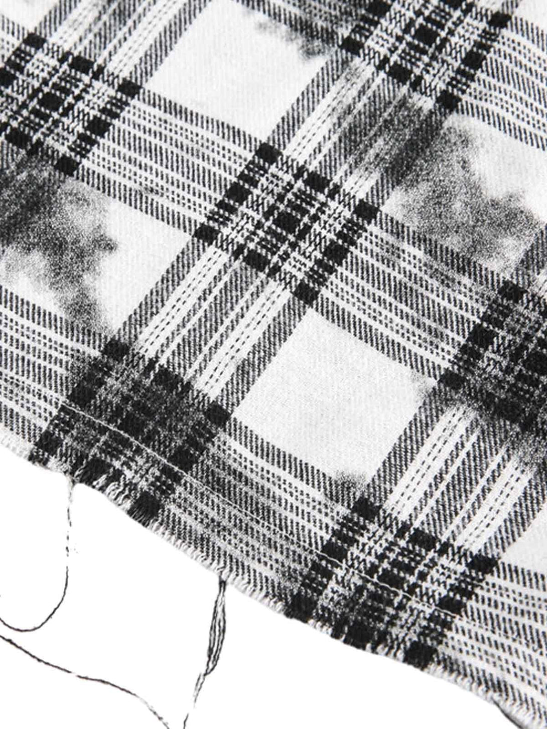 Zoomed-in texture of TALISHKO's distressed plaid lace shirt, showcasing intricate fabric details.